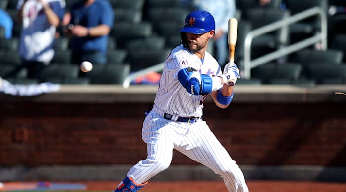Mets right fielder Michael Conforto leans into a pitch in the strike zone. He was incorrectly awarded first base, which forced in the winning run against the Marlins.